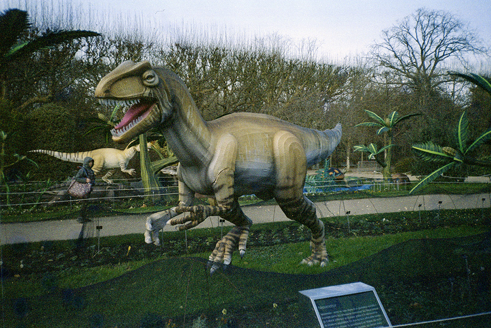 a sculpture of a walking bipedal dinosaur